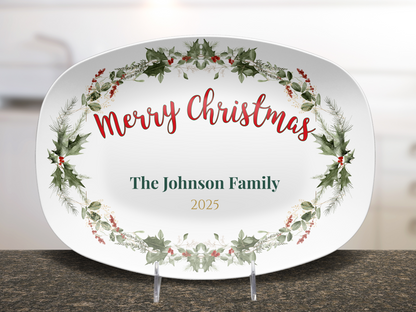 Decorative Christmas serving platter with wreath design and text on a kitchen counter.